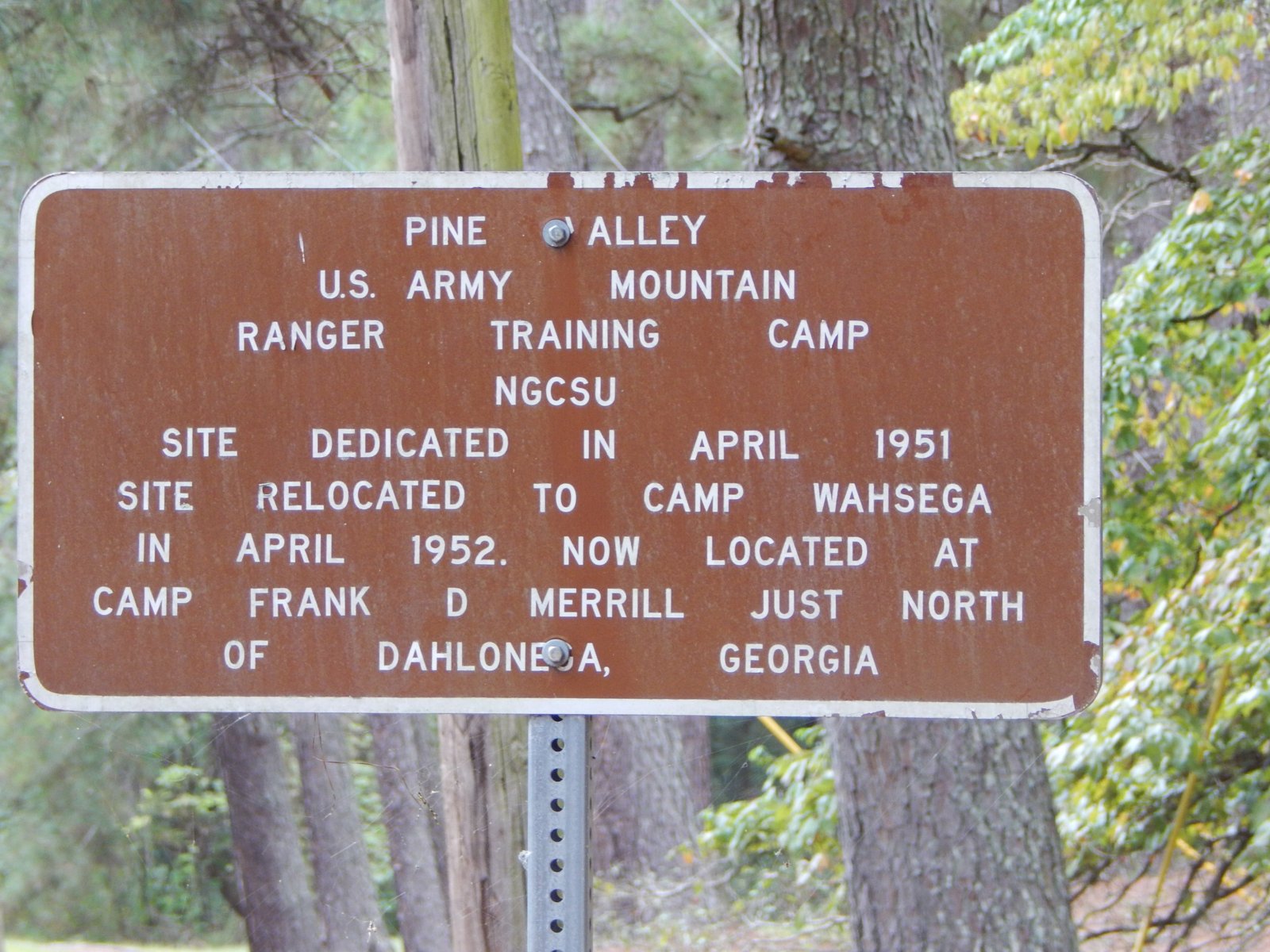 Brown sign reading Pine Valley, U.S. Army Mountain Ranger Training Camp, site dedicated in April 1951
